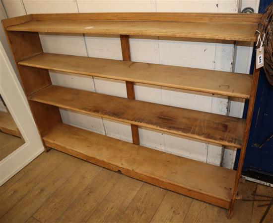 An Arts & Crafts pine three shelf open bookcase, with pegged joints W.168cm